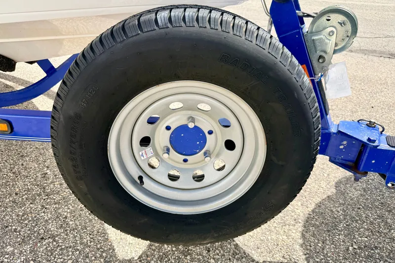 Slide: The Image of Trailer wheel of a 2007 Moomba Outback V boat on a blue frame. - 86