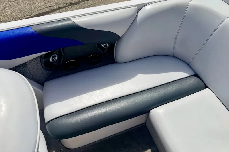 Slide: The Image of 2007 Moomba Outback V boat interior with white and black seating, blue accent, and speakers. - 31