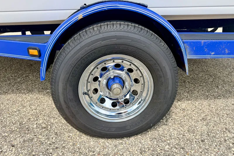 Slide: The Image of 2007 Moomba Outback V trailer wheel with chrome rim and Goodyear tire. - 83