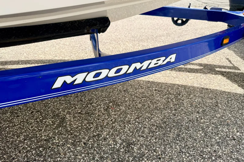 Slide: The Image of Blue Moomba trailer for 2007 Outback V boat on asphalt surface. - 85