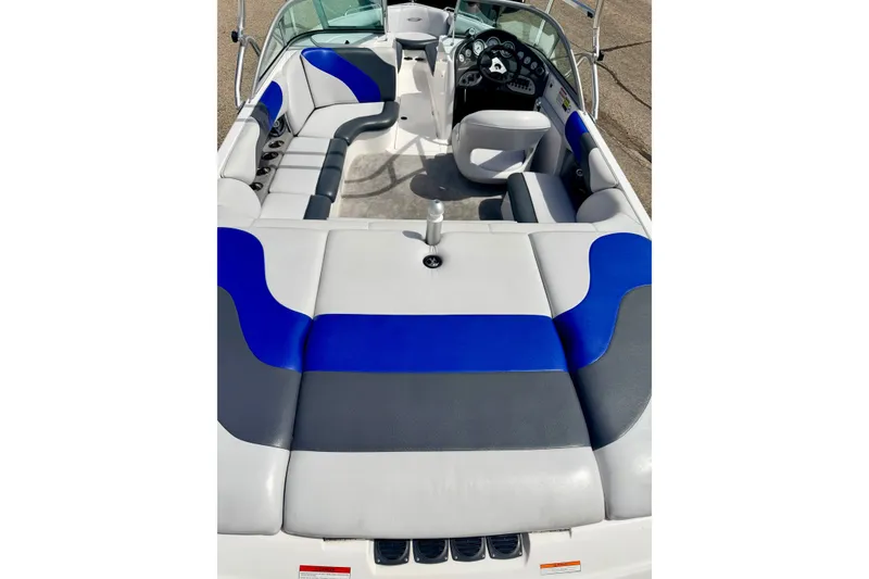 Slide: The Image of 2007 Moomba Outback V boat interior with blue and gray seating, steering console, and cup holders. - 30