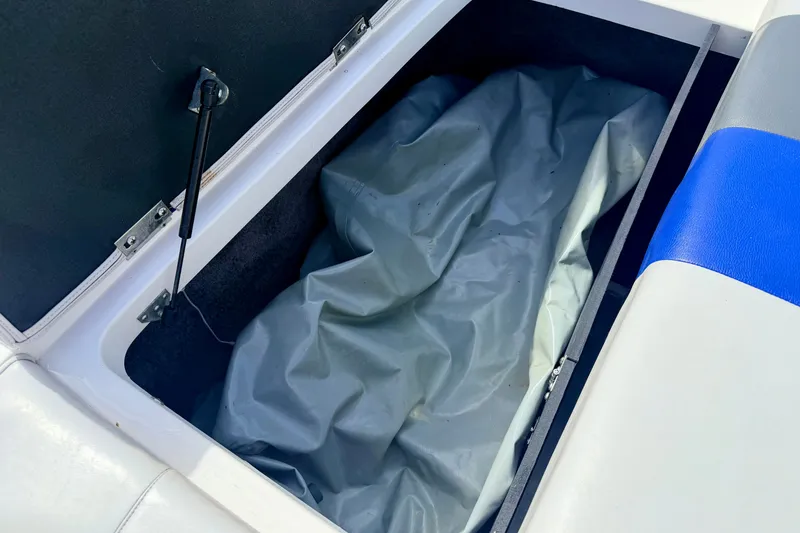 Slide: The Image of Storage compartment in a 2007 Moomba Outback V boat with blue and white seating. - 24