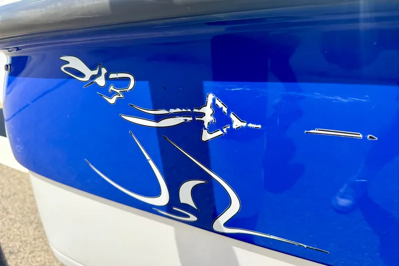 Slide: The Image of 2007 Moomba Outback V boat with blue and white graphics, close-up view. - 18