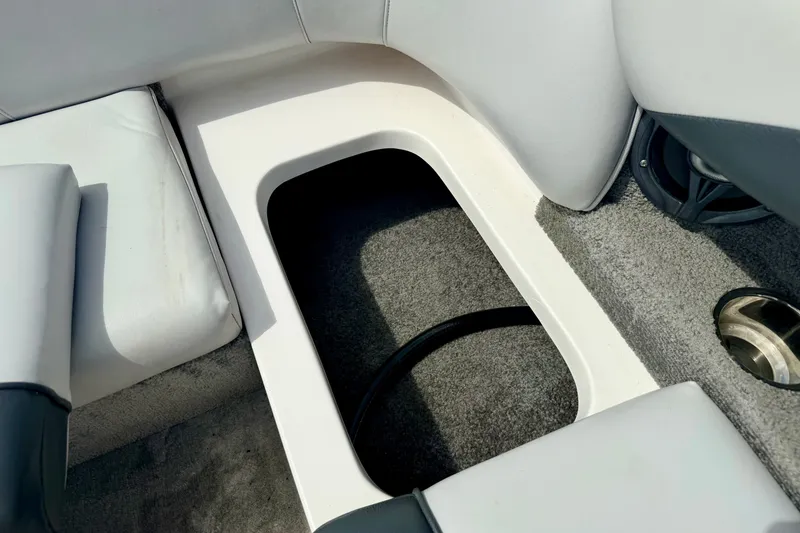 Slide: The Image of 2007 Moomba Outback V interior storage compartment with gray upholstery and carpeted flooring. - 39