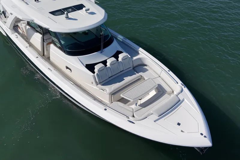 Slide: The Image of The 2023 Tiara Yachts 48 LS is a sleek boat with a spacious deck and luxurious seating. - 7