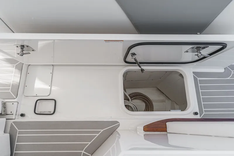 Slide: The Image of Interior view of a 2023 Tiara Yachts 48 LS with storage compartment and gray upholstery. - 42