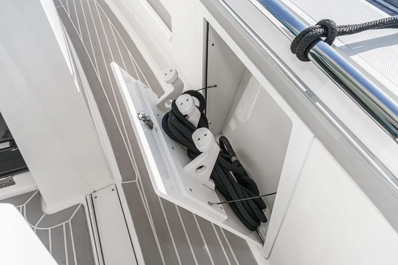 Slide: The Image of A storage compartment on a Tiara Yachts 48 LS with ropes and holders. - 40