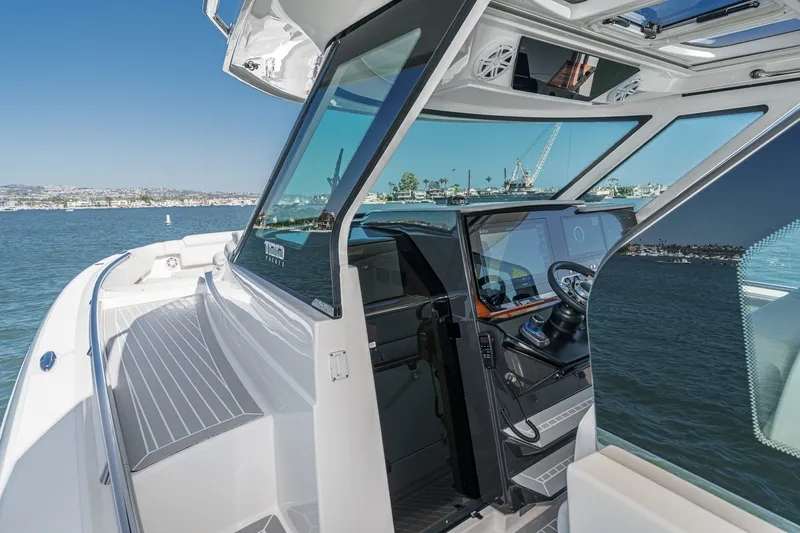 Slide: The Image of The image shows the cockpit of a 2023 Tiara Yachts 48 LS with modern design and panoramic views. - 33