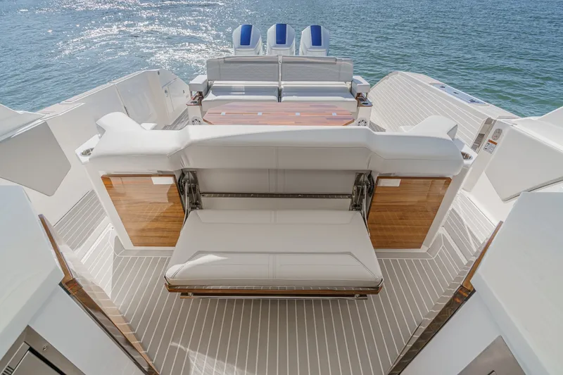 Slide: The Image of The image shows the stern of a 2023 Tiara Yachts 48 LS with luxurious seating. - 19
