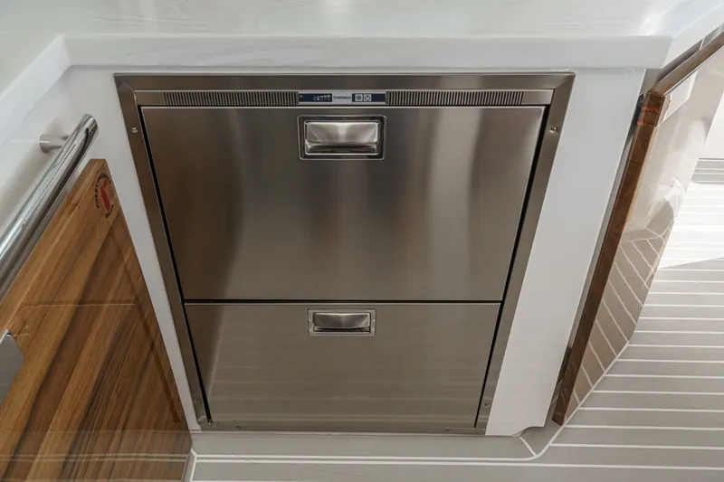 Slide: The Image of The 2023 Tiara Yachts 48 LS features a modern stainless steel double drawer in the galley. - 29