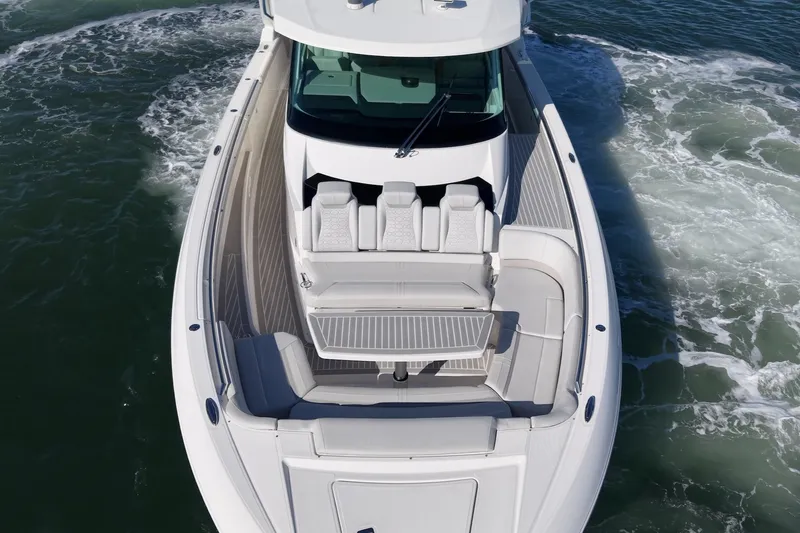 Slide: The Image of The 2023 Tiara Yachts 48 LS is cruising on the water. It features a sleek, modern design. - 11