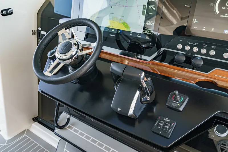 Slide: The Image of The image shows the helm of a 2023 Tiara Yachts 48 LS with modern navigation systems. - 32