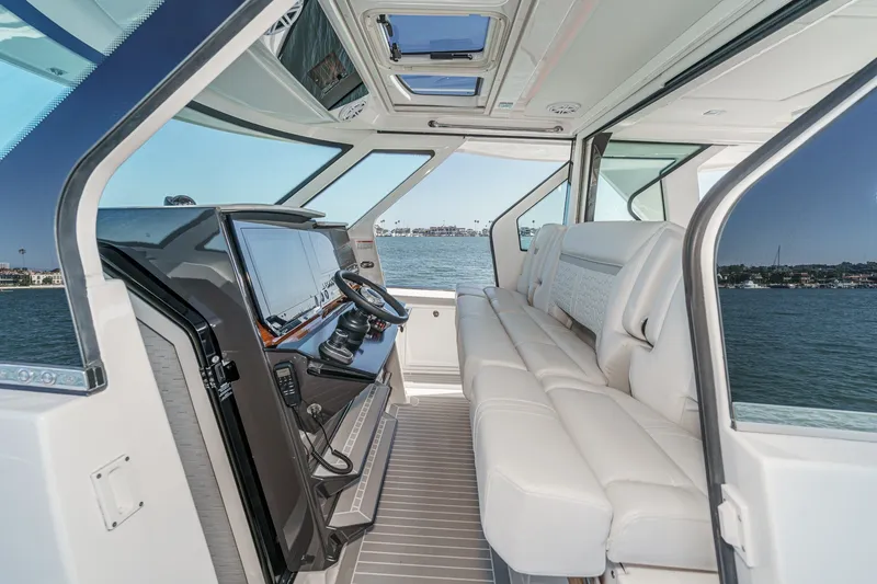 Slide: The Image of Interior view of a luxury yacht with white leather seating and a modern helm station. - 34