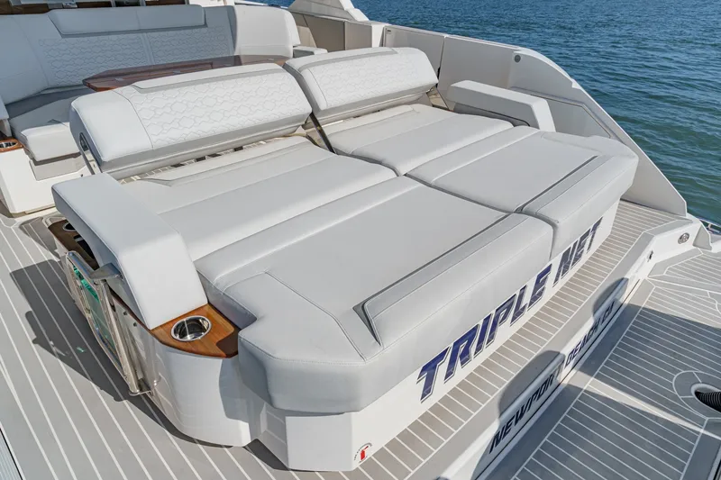 Slide: The Image of The image shows the stern of a 2023 Tiara Yachts 48 LS with luxurious lounging areas. - 23