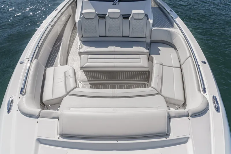 Slide: The Image of The image shows the spacious, luxurious deck of a 2023 Tiara Yachts 48 LS with sleek white upholstery. - 14