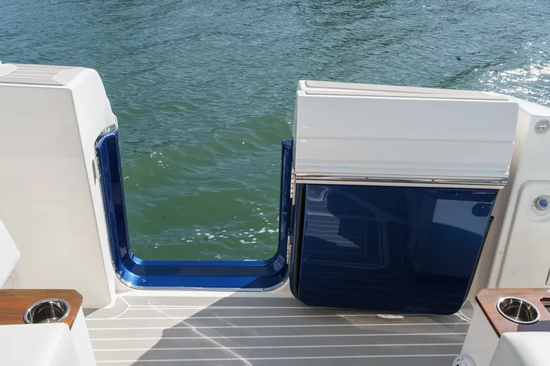 Slide: The Image of The 2023 Tiara Yachts 48 LS features a sleek swim platform with access to the water. - 24