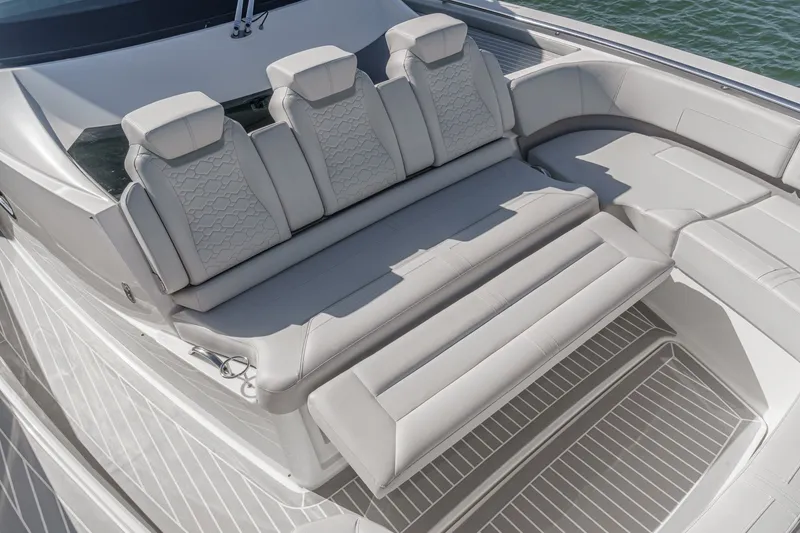 Slide: The Image of The image shows the luxurious aft deck of a Tiara Yachts 48 LS with elegant, cushioned seating. - 15