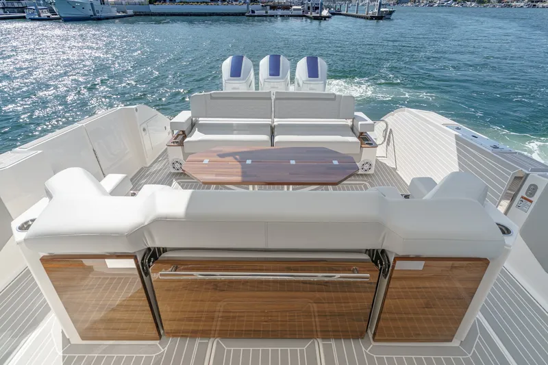 Slide: The Image of The image shows the stern of a 2023 Tiara Yachts 48 LS with luxurious seating and two engines. - 18