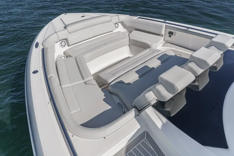 Slide: The Image of The image shows the spacious foredeck of a 2023 Tiara Yachts 48 LS with luxurious seating. - 12