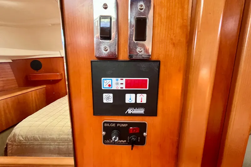 Slide: The Image of Control panel on a 2000 Moody 42 yacht, featuring air system and bilge pump. - 36