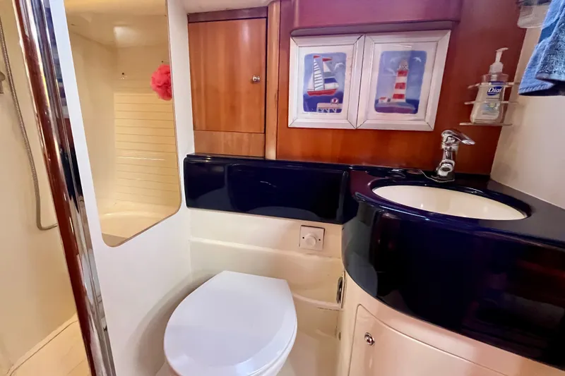 Slide: The Image of Bathroom interior of 2000 Moody 42 yacht with shower, sink, and nautical decor. - 20