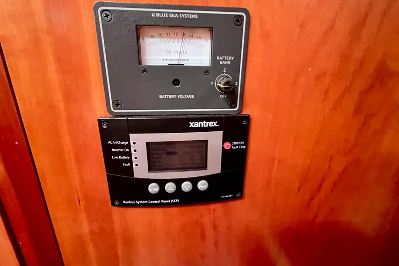Slide: The Image of Control panel on a 2000 Moody 42 yacht, featuring Blue Sea Systems and Xantrex displays. - 39