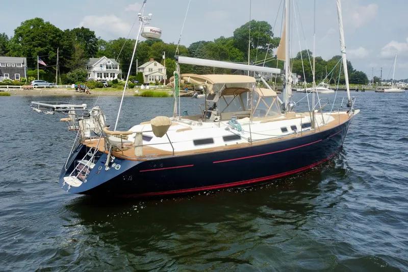 Slide: The Image of Sailboat Moody 42, 2000 model, anchored near shoreline with houses in background. - 45