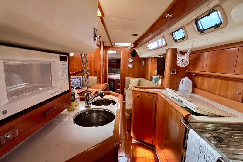 Slide: The Image of Interior of a 2000 Moody 42 yacht with wooden cabinetry and modern amenities. - 22