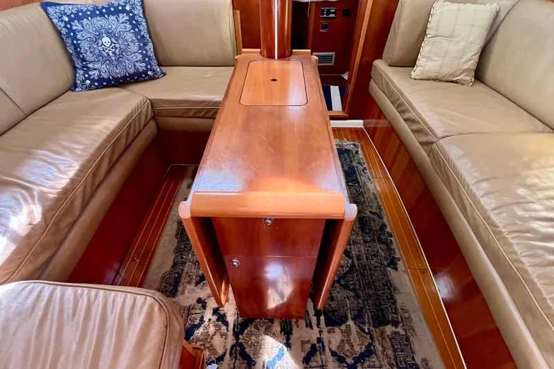 Slide: The Image of Luxurious interior of a 2000 Moody 42 yacht with leather seating and wooden table. - 28
