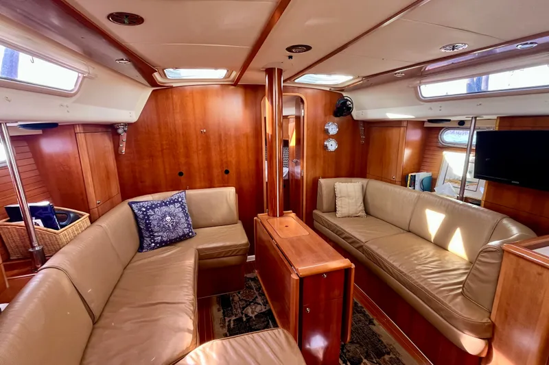 Slide: The Image of Luxurious interior of a 2000 Moody 42 yacht with leather seating and wooden finishes. - 11