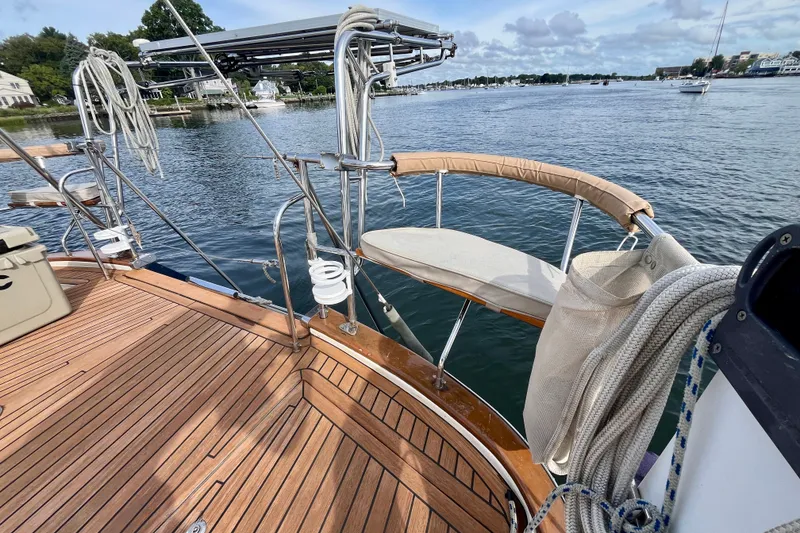 Slide: The Image of Sailboat deck with wooden flooring, ropes, and scenic waterfront view. Moody 42, year 2000. - 29