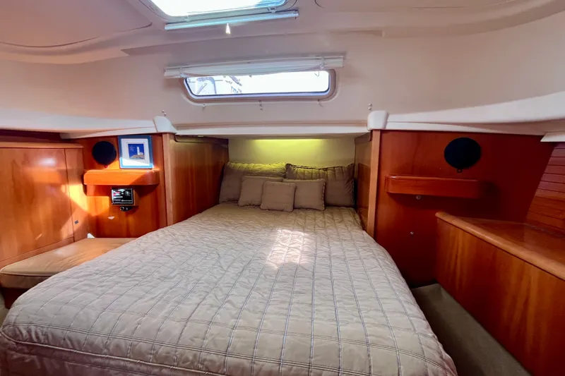 Slide: The Image of Cozy cabin interior of 2000 Moody 42 yacht with wooden finish and skylight. - 16