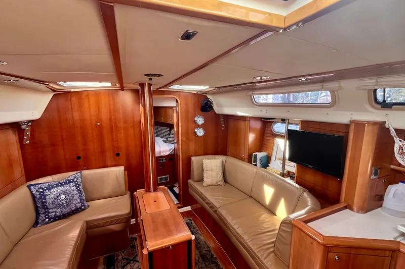 Slide: The Image of Luxurious interior of a 2000 Moody 42 yacht with elegant wood finish and comfortable seating. - 10