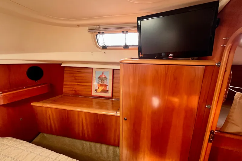 Slide: The Image of Cozy cabin interior of 2000 Moody 42 yacht with wooden finish and mounted TV. - 18