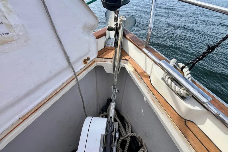 Slide: The Image of Anchor chain and ropes on a 2000 Moody 42 sailboat deck by the water. - 31