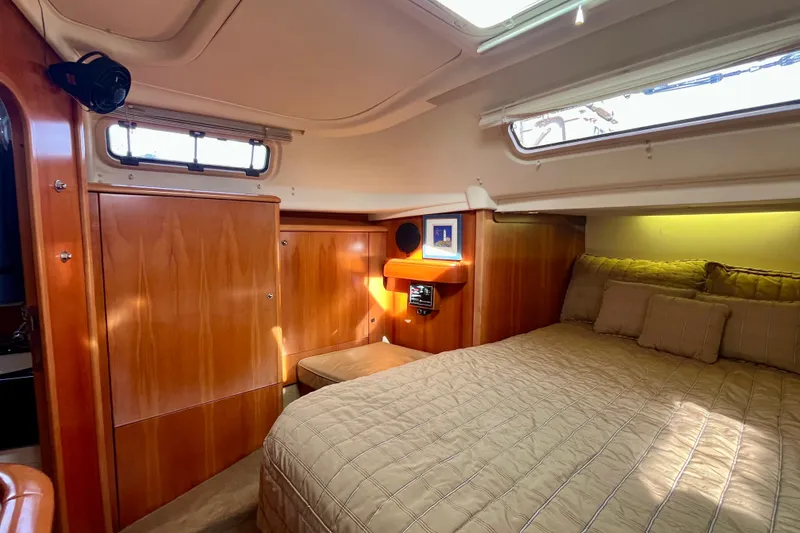 Slide: The Image of Cozy cabin interior of 2000 Moody 42 yacht with wood paneling and comfortable bedding. - 17