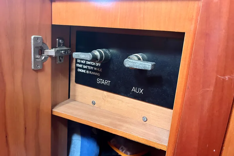 Slide: The Image of Control panel inside a Moody 42 yacht, featuring start and auxiliary switches. - 41