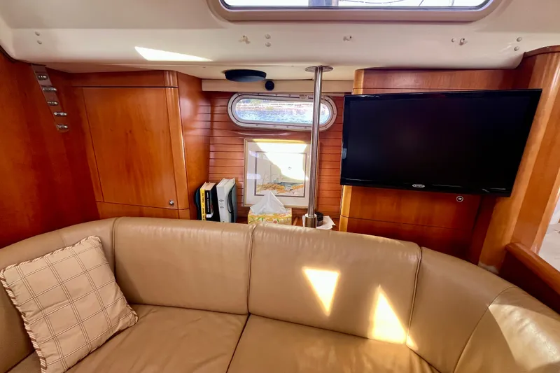 Slide: The Image of Luxurious interior of a 2000 Moody 42 yacht with leather seating and a mounted TV. - 6