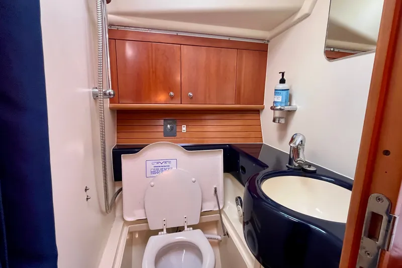 Slide: The Image of Compact marine bathroom in 2000 Moody 42 yacht with wooden cabinets and modern fixtures. - 9
