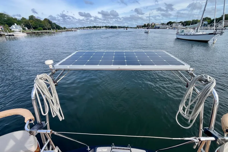 Slide: The Image of Sailboat with solar panel on Moody 42, 2000 model, docked in a scenic harbor. - 30