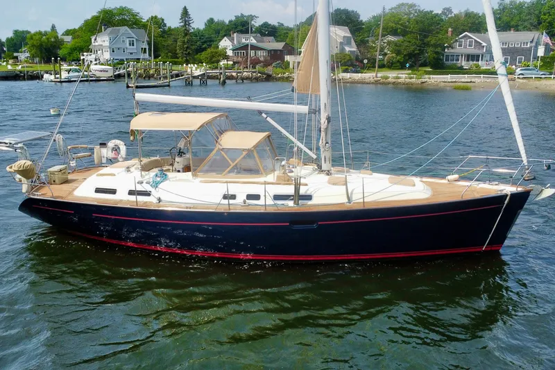 The Image of Sailboat Moody 42, 2000 model, docked in a scenic waterfront setting. - 0