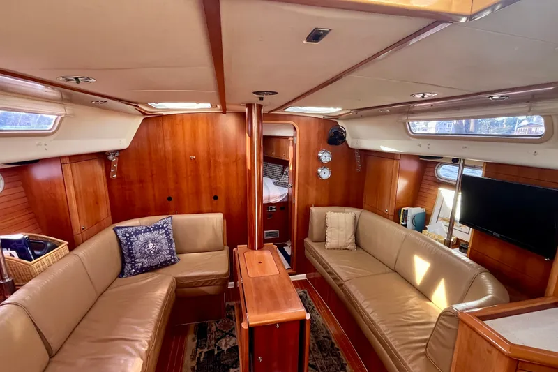 Slide: The Image of Luxurious interior of a 2000 Moody 42 yacht with elegant wood finish and comfortable seating. - 4