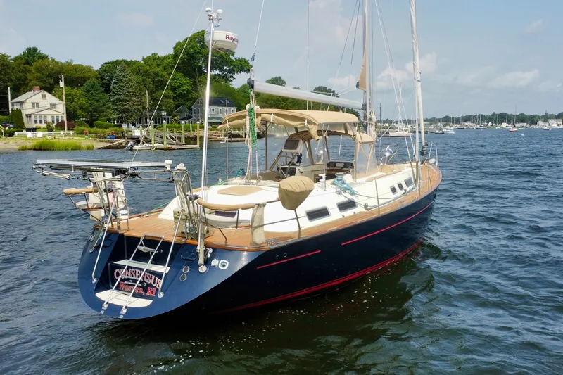 Slide: The Image of Sailboat Moody 42 (2000) on calm waters near a scenic shoreline. - 3