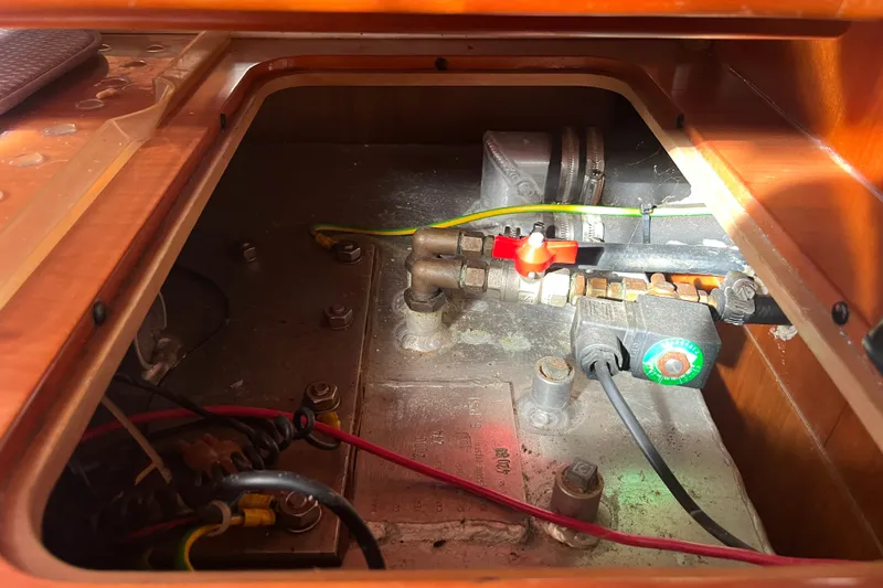 Slide: The Image of Engine compartment of a 2000 Moody 42 yacht, featuring wiring and mechanical components. - 43