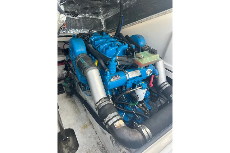 Slide: The Image of Engine compartment of a 2005 Tiara Yachts 2900 Coronet, showcasing a blue marine engine. - 21
