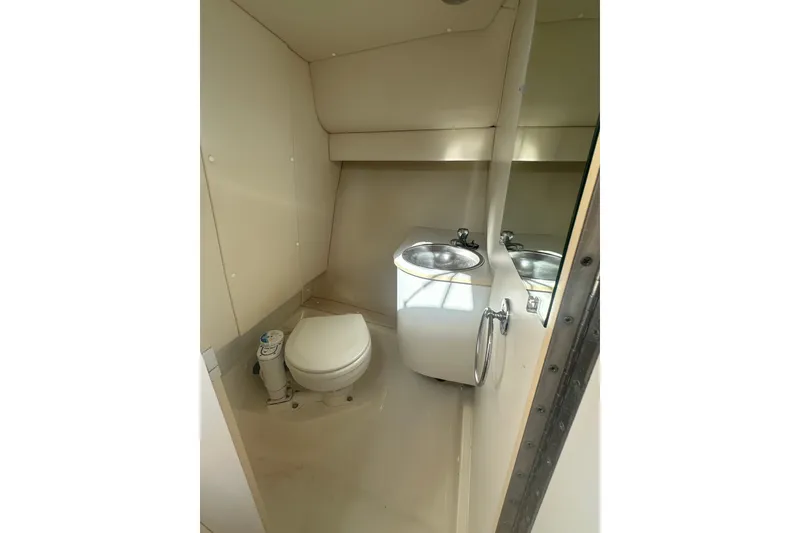 Slide: The Image of Compact bathroom in 2005 Tiara Yachts 2900 Coronet, featuring toilet and sink. - 15