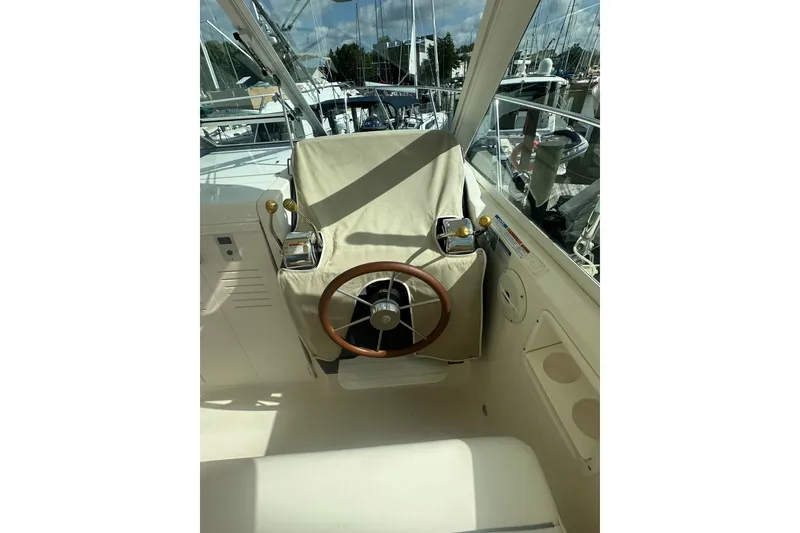 Slide: The Image of Helm of 2005 Tiara Yachts 2900 Coronet with covered steering wheel and controls. - 13