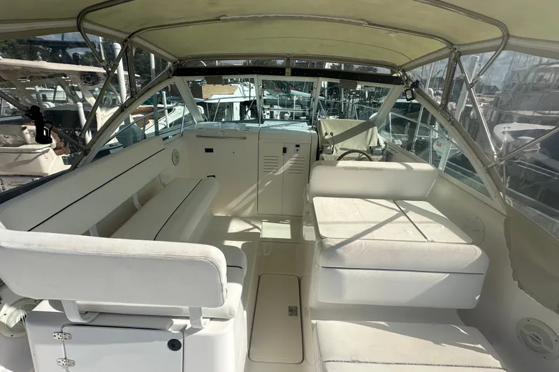 Slide: The Image of 2005 Tiara Yachts 2900 Coronet interior with white seating and helm, docked at marina. - 11