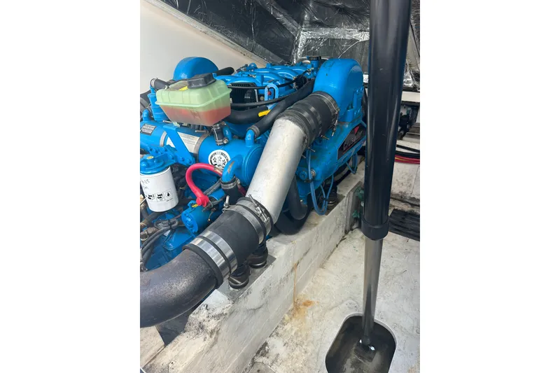 Slide: The Image of Engine compartment of a 2005 Tiara Yachts 2900 Coronet, featuring a blue engine. - 22
