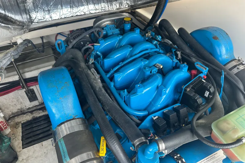 Slide: The Image of Engine compartment of a 2005 Tiara Yachts 2900 Coronet, featuring a blue marine engine. - 24
